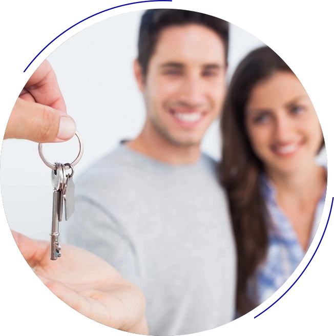 A man and woman holding keys to their new home.